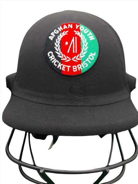 The Custom Shrey Cricket Helmets with Club Logo by Shrey feature a black design with a circular Afghan Youth Cricket Bristol badge, red and green club logo, and laurel wreath—ideal for personalized embroidered helmets.