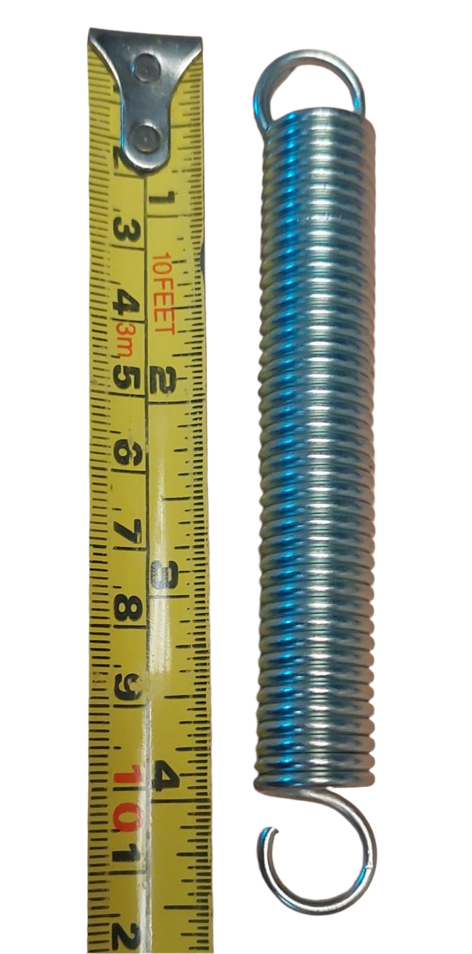 The Martin Berrill Sports Replacement Spring for Spring Back Stumps, featuring hooks at both ends, is shown beside a yellow tape measure reading about 5 inches, highlighted against a white background.