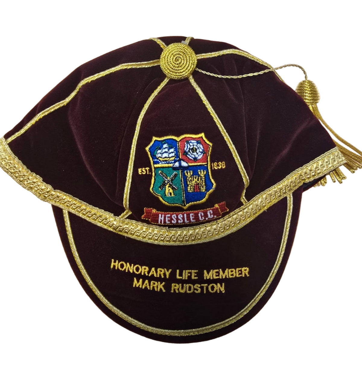 The Custom, Honour & Commemorative Cap by Martin Berrill Sports features maroon velvet with gold trim, tassel, embroidered crest, and can be personalized (e.g., "Honorary Life Member Mark Rudston and Hessle C.C., 1890") with colorful club symbols.