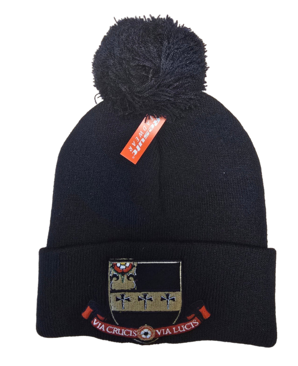 The Martin Berrill Sports Custom Branded Bobble Hat is a black knit beanie with a pom-pom, coat of arms patch, “VIA CRUCIS VIA LUCIS” motto on the fold, and a red “TOGHE POWER” tag.