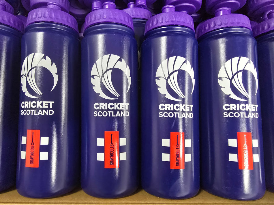 Rows of purple Martin Berrill Sports Customised Branded Water Bottles display a white thistle graphic, your Club or School logo, and red labels boldly stating DRINK ENOUGH in white text.