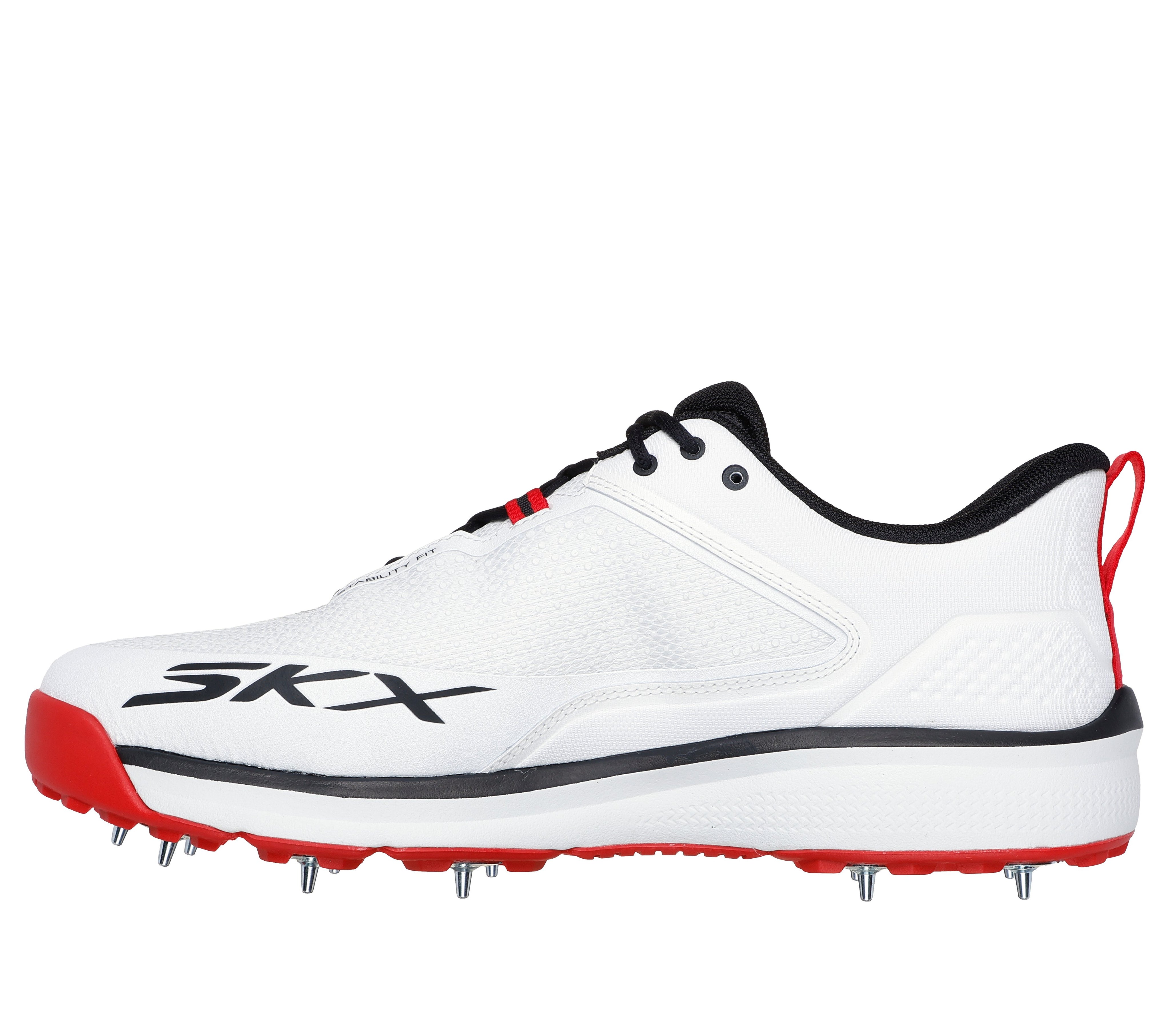 The Skechers Cricket Elite Cricket Shoe is a white athletic shoe with black and red accents, metal spikes on the sole, SKX branding on the side, a heel pull tab, and an Arch Fit insole for comfort.