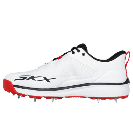 The Skechers Cricket Elite Cricket Shoe is a white athletic shoe with black and red accents, metal spikes on the sole, SKX branding on the side, a heel pull tab, and an Arch Fit insole for comfort.