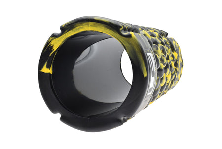 A close-up of the Urban Fitness Massage Roller 33 x 14cm by Urban Fitness, featuring a black and yellow bumpy surface with a hollow interior, designed for muscle recovery and physical therapy.