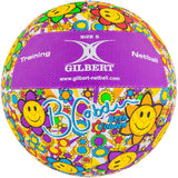 The Gilbert Ambassador Signature Netball by Gilbert is a size 5 netball featuring a vibrant yellow smiley-face flower pattern, purple panels, and printed with "Training Netball," "Gilbert," and Beth Cobden's signature.