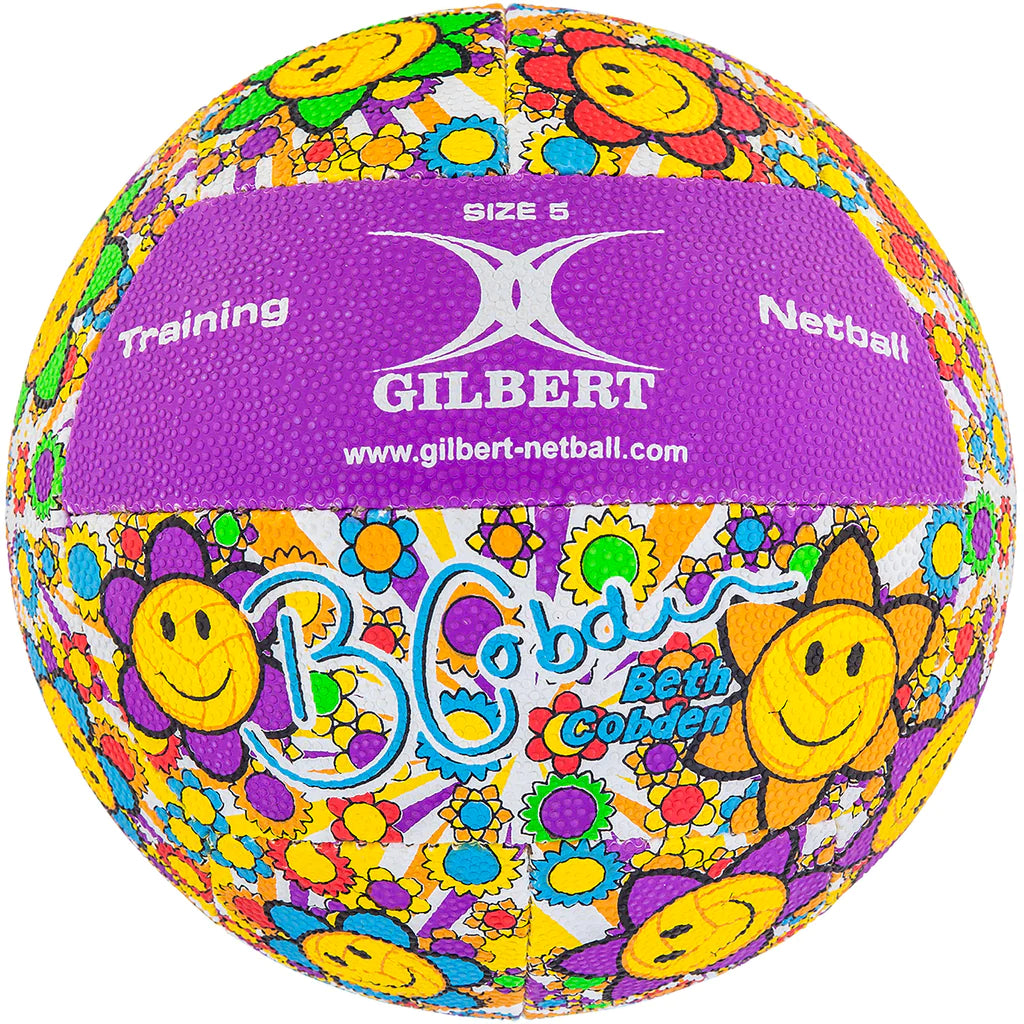 The Gilbert Ambassador Signature Netball by Gilbert is a size 5 netball featuring a vibrant yellow smiley-face flower pattern, purple panels, and printed with "Training Netball," "Gilbert," and Beth Cobden's signature.