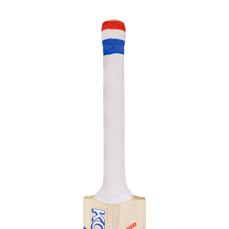 The image shows the handle of a Kookaburra Rapid Pro Players Edition Cricket Bat 2026, wrapped in white grip tape with a blue band and red top. The upper part of the wooden bat by Kookaburra is also partially visible.