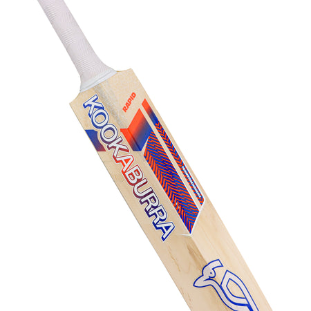 A close-up of the Kookaburra Rapid 6.1 Special Cricket Bat 2026, featuring a white handle, blue and red KOOKABURRA branding with geometric patterns, and the iconic bird logo near the bottom of this lightweight bat.