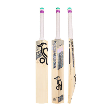 Three views of the Kookaburra Prism Natalie Sciver-Brunt Pro Players Replica Cricket Bat 2026 are shown: front, side, and angled. The English Willow bat features a light wood finish, white handle with green and purple bands, and bold black Kookaburra branding.