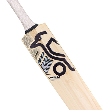 A close-up of the Kookaburra Prism Pro 2.1 Elite Junior Cricket Bat 2026 shows its English willow build, white handle, and black geometric graphics with a stylized bird. The bat features the label PRO 2.1 ELITE and is crafted by Kookaburra.