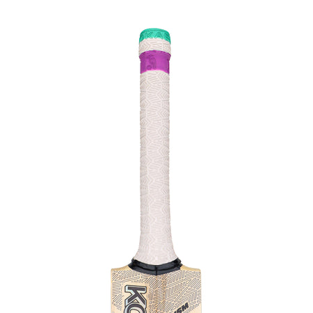 A close-up of the Kookaburra Prism Pro 2.1 Elite Junior Cricket Bat 2026 handle, featuring a textured light-colored grip, green cap, and purple section, with part of the English willow blade from Kookaburra also visible.