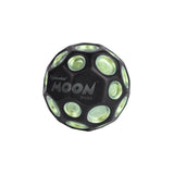 The Waboba Dark Side of Moon Ball is a green, hyper-bouncing ball by Waboba, featuring crater-like dimples and the words "Waboba MOON BALL" printed in white on its side.