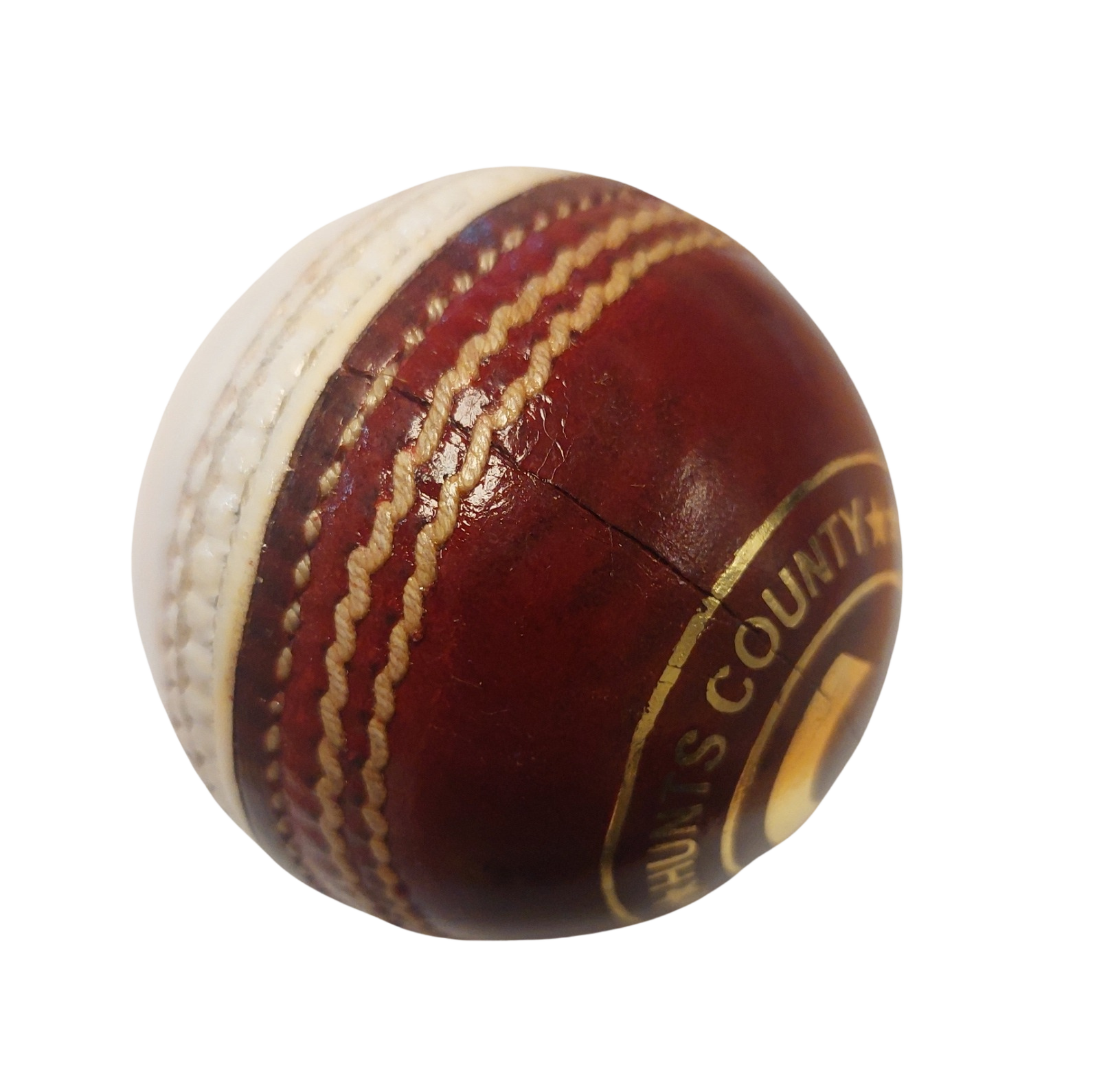 A close-up of the Hunts County Club Training Ball (Red/White) by Hunts County, featuring red leather, white stitching, visible branding, and a surface crack—ideal for swing or spin training—set against a white background.