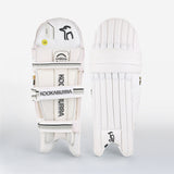 Two white Kookaburra Ghost Pro Batting Pads 2026 shown front and back; the front features thick vertical padding, while the back displays KOOKABURRA and HYBRID-labeled straps with visible protective padding.