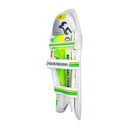 The Kookaburra Kahuna Pro Batting Pads 2026 feature white, green, and yellow details, the Kookaburra logo, and three Velcro straps for comfort and style. They stand upright against a plain white background.