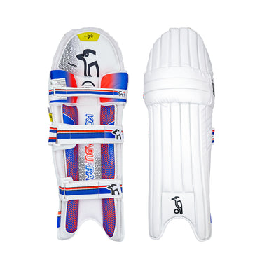 Two Kookaburra Rapid 2.1 Batting Pads 2026 are shown side by side: one displays vibrant blue, red, and yellow inner accents with fastening straps, while the other shows the plain white outer and vertical padding for protection.