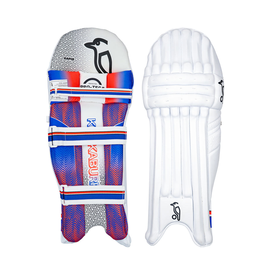 Two cricket batting pads are shown: on the left, the Kookaburra Rapid 4.1 Batting Pads 2026 by Kookaburra with a vibrant blue, red, and white design; on the right, a plain white pad with curved padding and subtle branding.