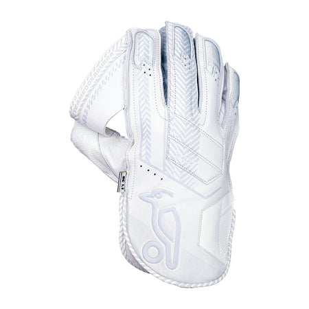 The Kookaburra SC 1.1 Wicket Keeping Gloves 2026 feature a white design with grey patterns, detailed stitching, and a stylized bird logo on the wristband, made from aniline sheep leather in a Shorti cut and shown angled to display the back and wrist.