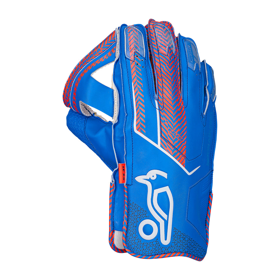 The Kookaburra LC 3.0 Wicket Keeping Gloves 2026 by Kookaburra features a blue design with red and white accents, a stylized bird logo, and geometric patterns on the back of the hand.