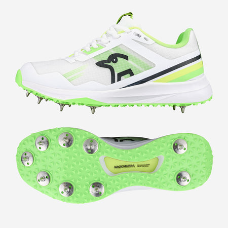 The Kookaburra KC 2.0 Cricket Spikes by Kookaburra feature a yellow/green design with metal spikes and a textured sole for superior traction. The side view shows the sleek shoe and brand logo, while the bottom highlights the spiked grip.