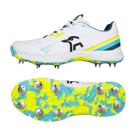 The Kookaburra KC 3.0 Cricket Spikes 2026, a lightweight white shoe with blue and yellow details, features metal spikes and a bold yellow, blue, and white camo sole for excellent grip—perfect for club players.