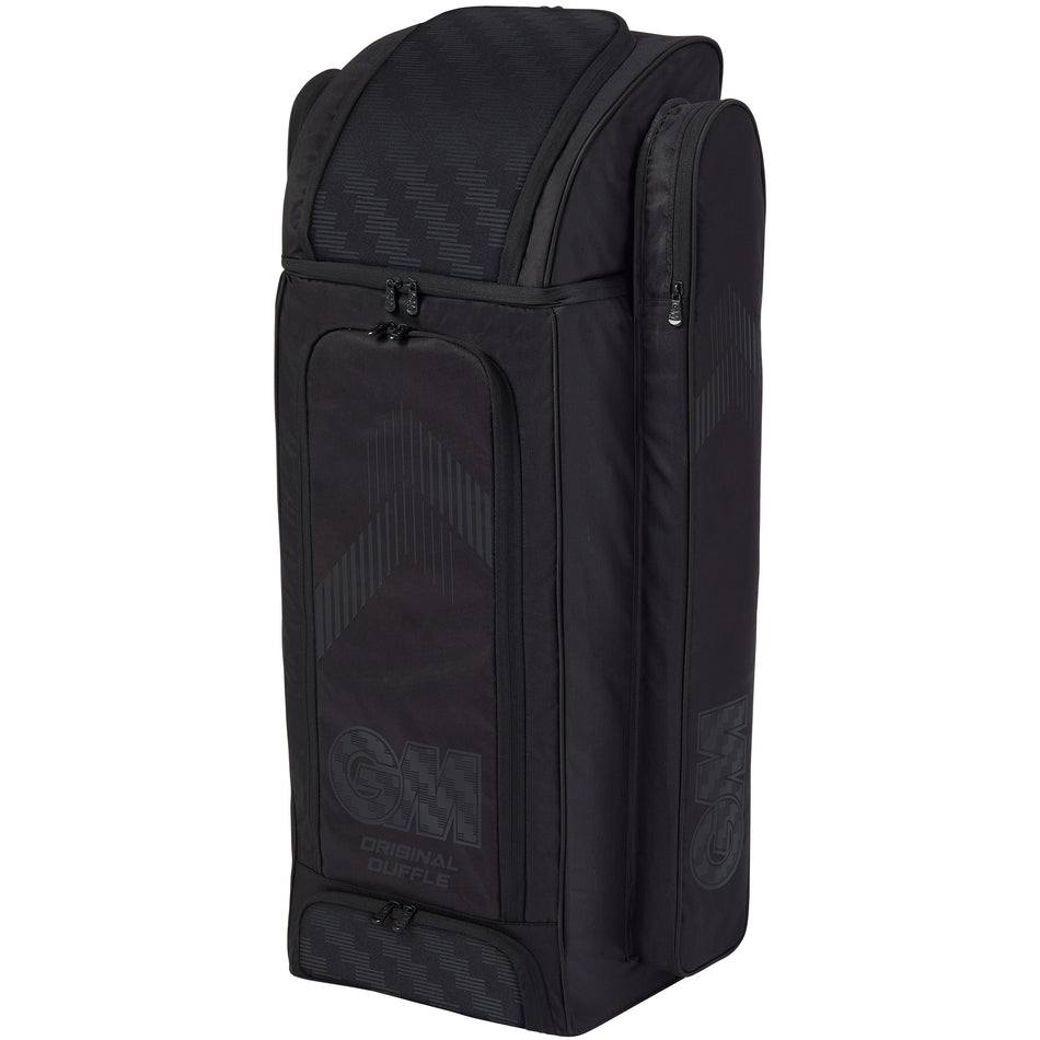 The Gunn & Moore Original Duffle 2026, a large black GM cricket kit bag with multiple zippered compartments for optimal storage, stands upright against a white background.
