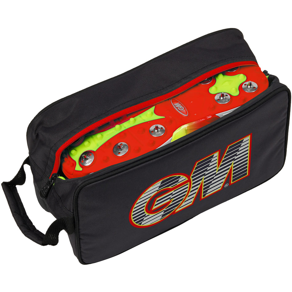 The Gunn & Moore Boot Bag 2026 is a black polyester cricket shoe bag with a red zipper, partly open to reveal red and neon green cleats inside. Featuring bold "GM" branding on the side, it's ideal for carrying your cricket gear.