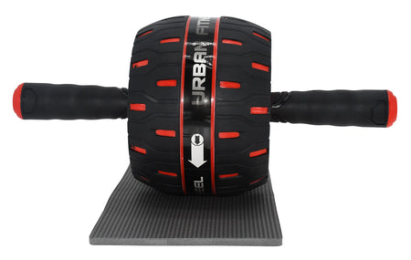 The Urban Fitness Rebound Ab Wheel, in black and red with two handles and a white arrow on the wheel, rests on a small gray mat. Branded by Urban Fitness, it’s ideal for building core strength.
