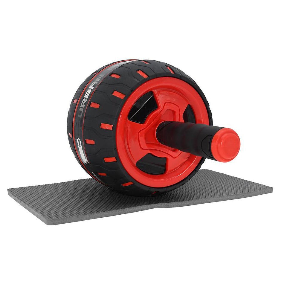 The Urban Fitness Rebound Ab Wheel by Urban Fitness is a black and red ab roller with padded handles and a spring-back mechanism, resting on a textured gray mat—ideal for core strength and resistance training.