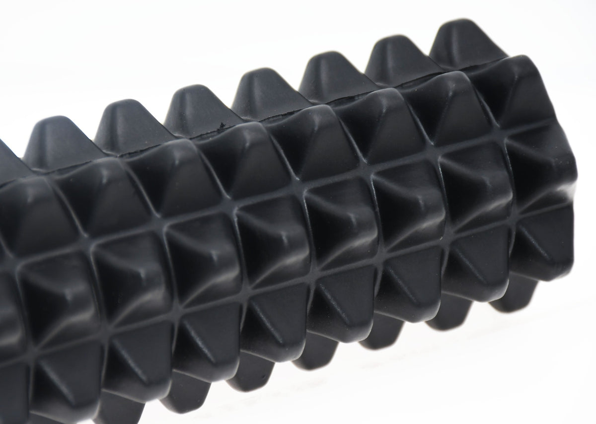 Close-up of the Urban Fitness EVA Mini Massage Roller by Urban Fitness, featuring a black textured surface with raised pyramid spikes for muscle recovery and portable physical therapy, shown against a white background.