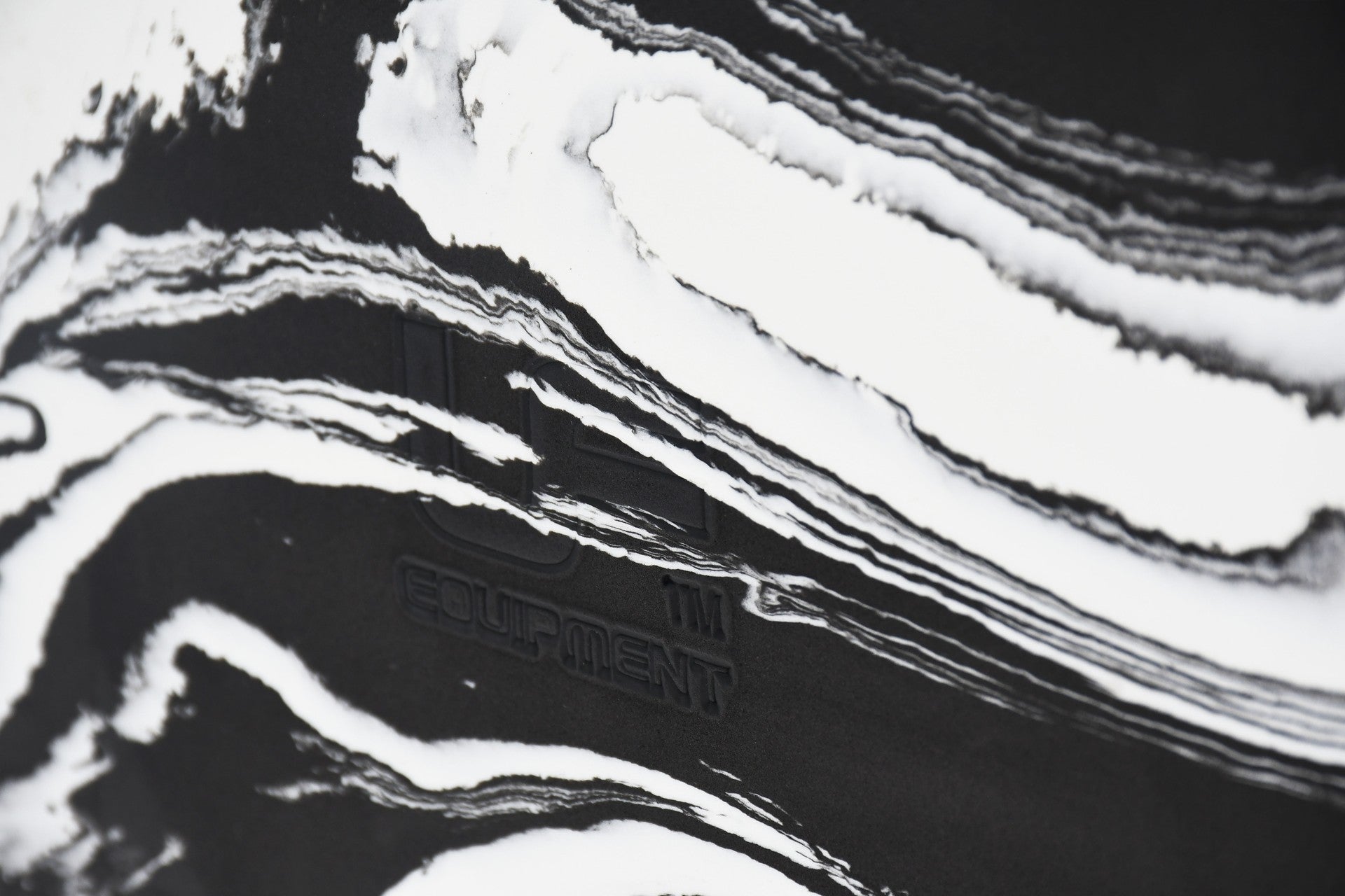 Close-up of the Urban Fitness Marbled Yoga Block, featuring white marbled wavy patterns on black and faintly embossed Urban Fitness branding.