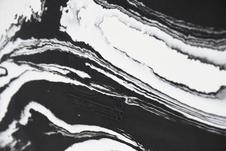 Close-up of the Urban Fitness Marbled Yoga Block, featuring white marbled wavy patterns on black and faintly embossed Urban Fitness branding.
