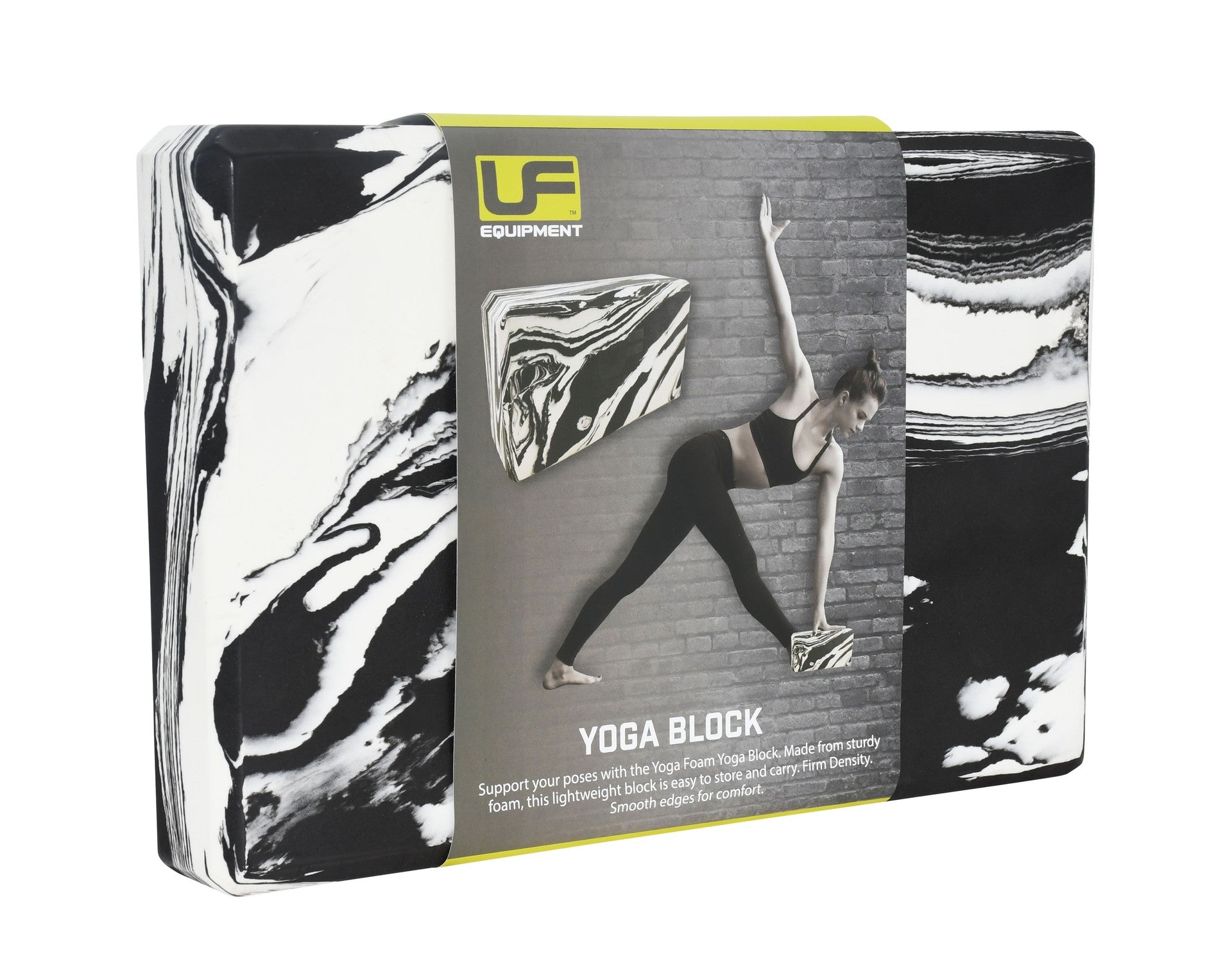 A black/white Urban Fitness Marbled Yoga Block in packaging displays a woman using the firm-density block for support in a yoga pose by a brick wall. The packaging features the Urban Fitness brand name.