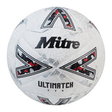 The Mitre Ultimatch Evo Football by Mitre is white and silver, showcasing bold branding, geometric black and red patterns, and thermally bonded seams for enhanced durability—ideal as a reliable match ball.