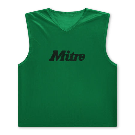 The Mitre Pro Training Bib in dark green features a sleeveless V-neck design with Hyperflow grooves for breathability and soft touch foam for comfort. "Mitre" is printed in black across the chest, ideal for lightweight football training.