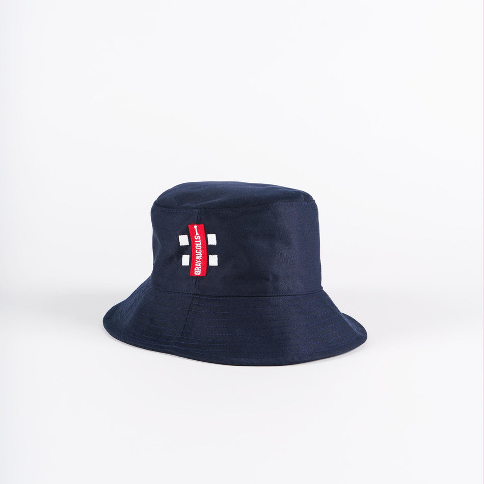 The Gray Nicolls Bucket Hat by Gray Nicolls features a navy design with a red tag and white text on the front, shown against a plain white background.