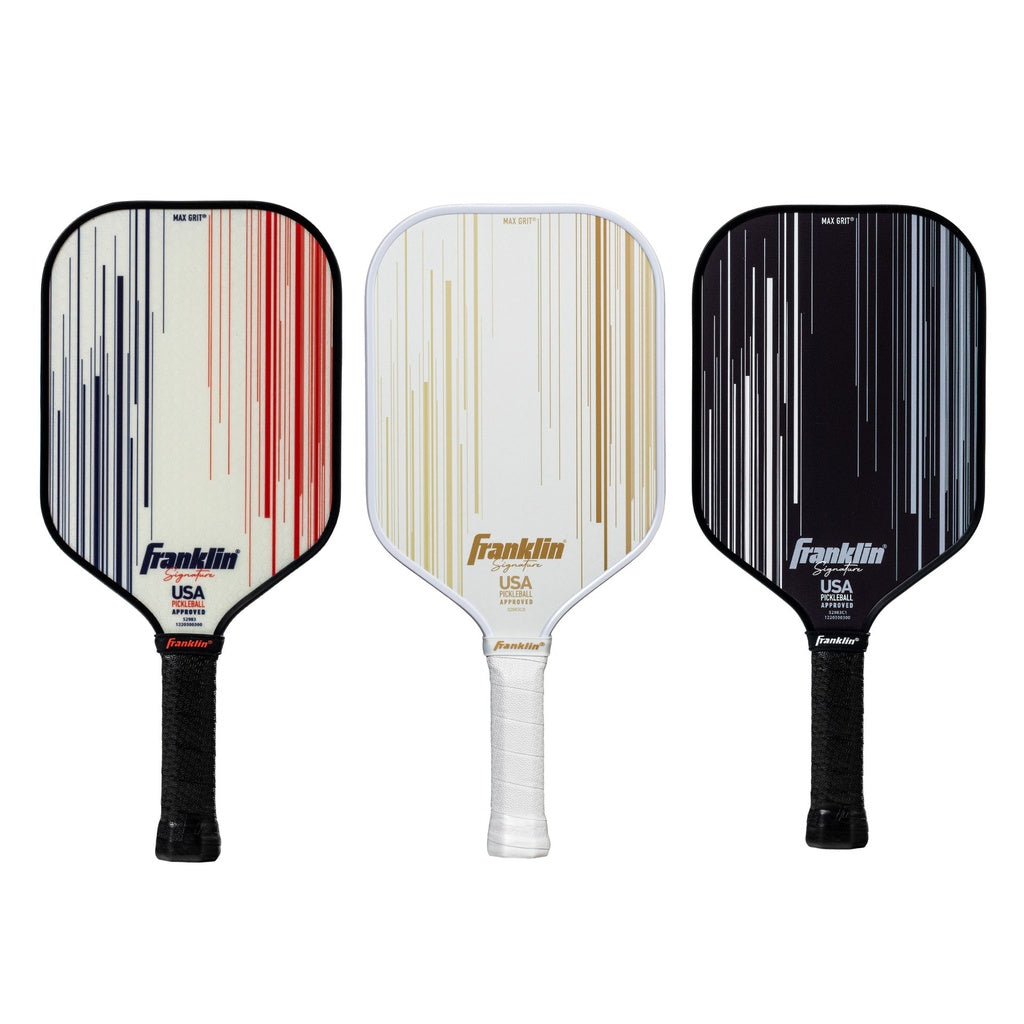 Three Franklin Signature Pro Series Pickleball Paddles stand upright, each with striped red/white, gold/white, or gold/black designs. Featuring MaxGrit surface tech and black or white grips, these are USA Pickleball certified.