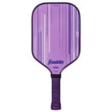 The Franklin Signature Pro Series Pickleball Paddle features a lilac design with vertical white and light purple stripes, a black grip, MaxGrit surface for control, and is USA Pickleball certified for official play.