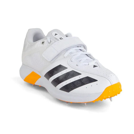 The Adidas 22YDS Vector White/Orange Cricket Spikes 2026 feature a white design with black stripes, orange sole details, metal spikes, lace-up closure, and a velcro strap—perfect for pace bowlers who want both style and support.