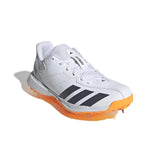 The Adidas Howzat White/Orange Cricket Spikes 2026 features Cloud White, Aurora Onix, and Lucid Tangerine colors with metal spikes, designed for top cricket performance. Displayed on a plain white background.