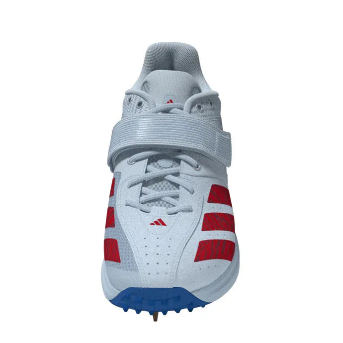 The Adidas 22YDS Vector White/Red/Royal Cricket Spikes 2026 feature a white design with red stripes, a blue toe area, and a gray strap over the laces, making them perfect cricket boots for pace bowlers.