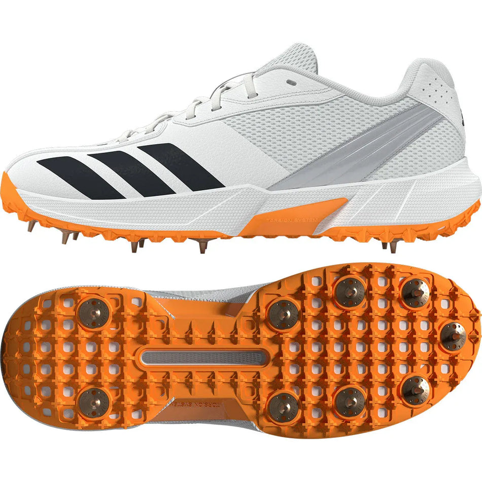 Adidas 22YDS White/Orange Cricket Spikes 2026 feature Cloud White with black stripes and Lucid Tangerine spikes, shown from the side and bottom to display grip and metal spikes—ideal for top cricket performance.