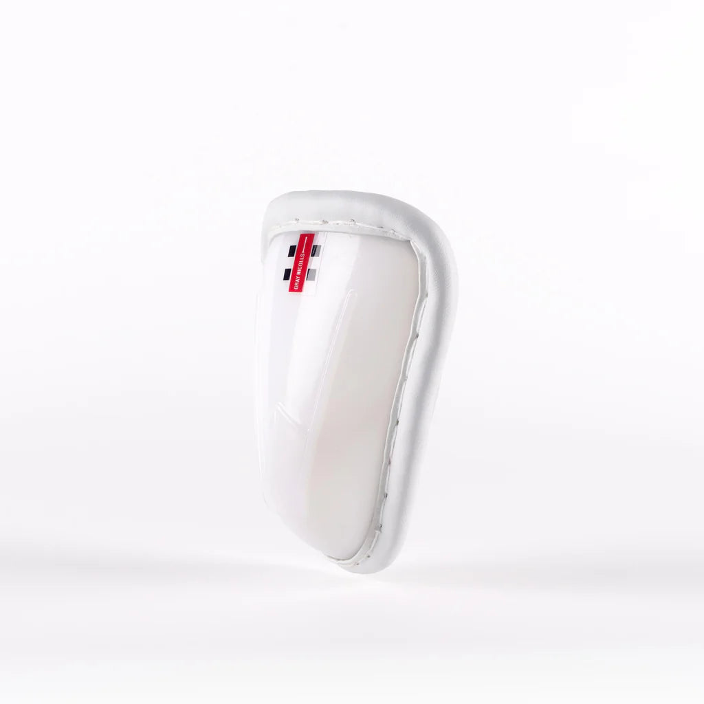 The Gray Nicolls Male Abdo Guard is a white protective sports cup featuring a padded rim and a small red and black Gray Nicolls label at the top, photographed against a plain white background.
