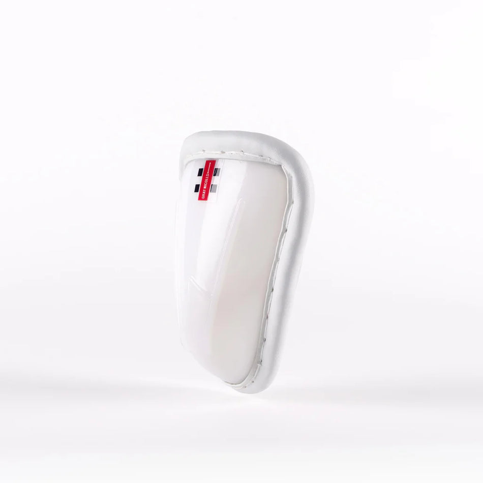 The Gray Nicolls Male Abdo Guard is a white protective sports cup featuring a padded rim and a small red and black Gray Nicolls label at the top, photographed against a plain white background.
