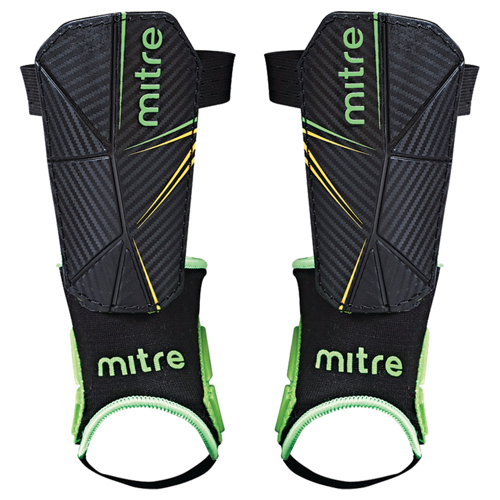 The Mitre Delta Ankle Shinguard features a black design with green and yellow accents, a textured surface, and black ankle supports with green trim for added protection; available in kids’ and men's sizes.