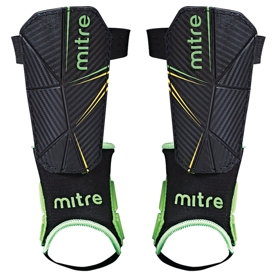 The Mitre Delta Ankle Shinguard features a black design with green and yellow accents, a textured surface, and black ankle supports with green trim for added protection; available in kids’ and men's sizes.