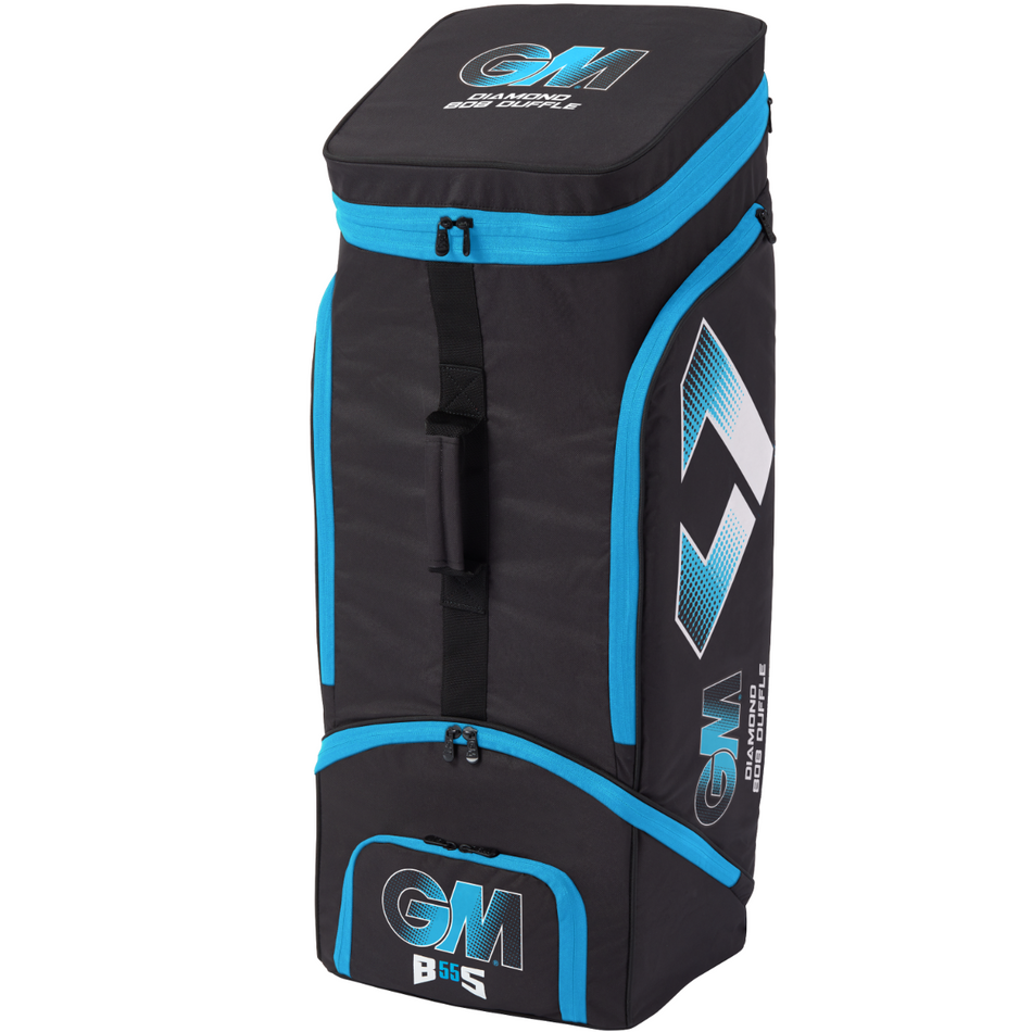 The Gunn & Moore 808 Duffle 2025 is a black and blue kit bag made from durable 600 denier polyester, with zippered compartments, dynamic volume expand feature, a side handle, and branded GM and B&S logos.