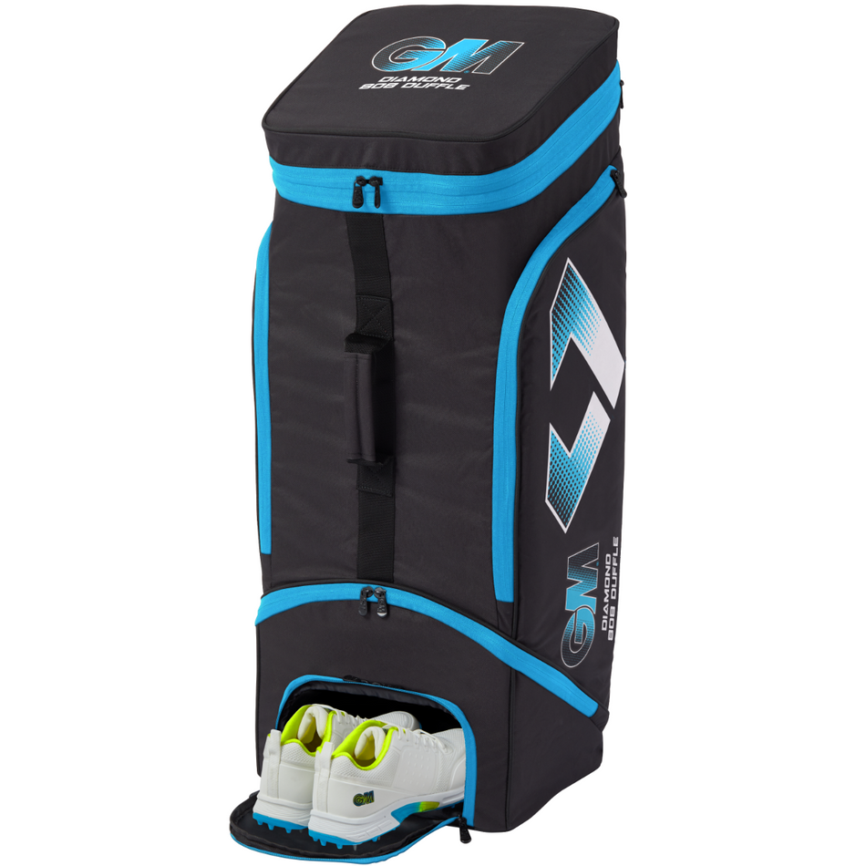 The Gunn & Moore 808 Duffle 2025, a black and blue cricket kit bag by Gunn & Moore, crafted from 600 denier polyester, stands upright with a zippered front pouch open to reveal white shoes with green and blue accents.