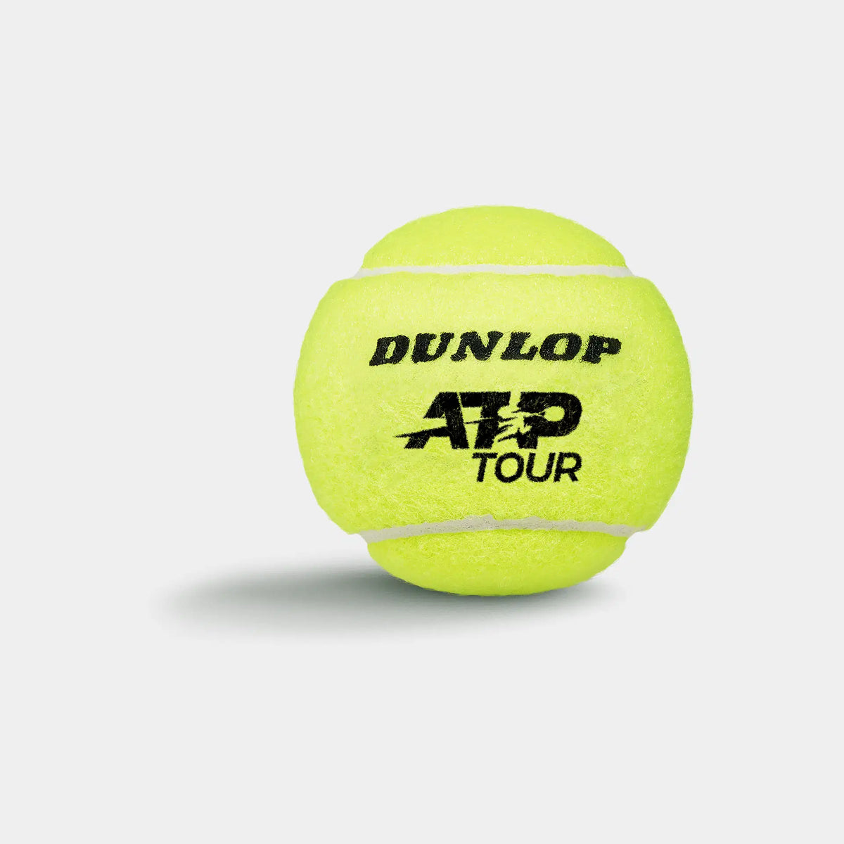 A Dunlop ATP Tour (4 Ball Tube) tennis ball, famed for tour-level performance, is shown in bright yellow against a plain white background with a soft shadow; DUNLOP ATP TOUR is printed on the ball in black.