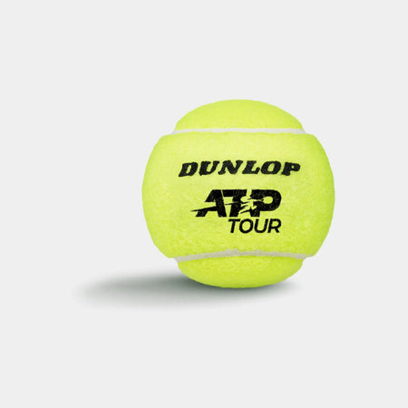 A Dunlop ATP Tour (4 Ball Tube) tennis ball, famed for tour-level performance, is shown in bright yellow against a plain white background with a soft shadow; DUNLOP ATP TOUR is printed on the ball in black.